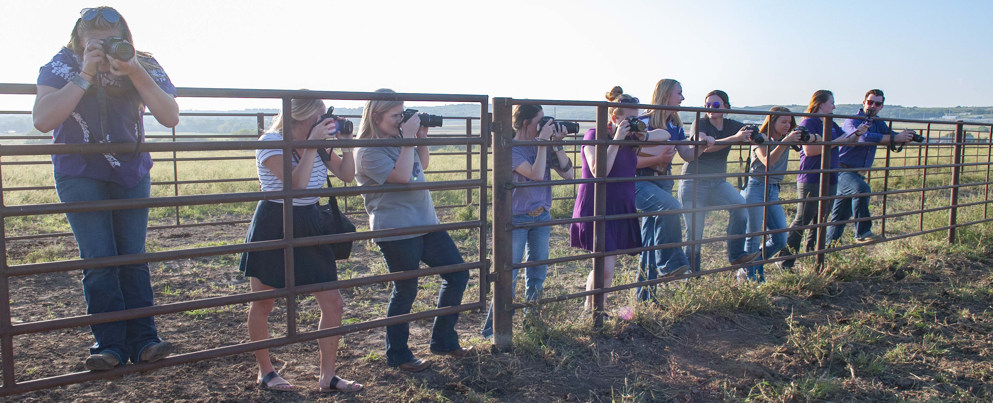 Students lined against a fence