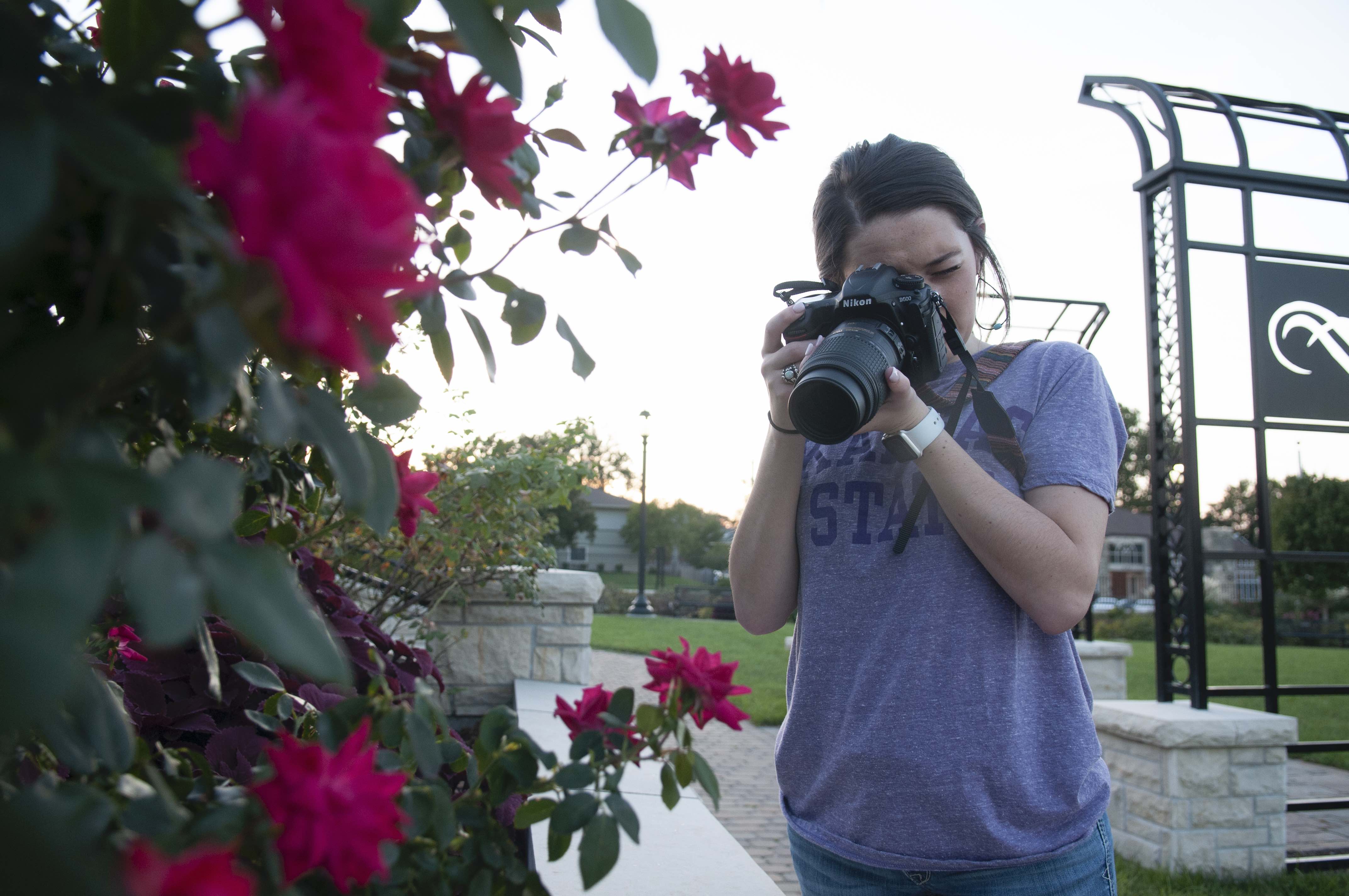 Kyndall Hill taking a picture in the KSU gardens.